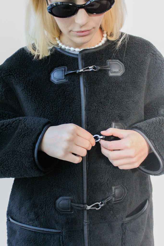 Dunst Collarless Buckled Shearling Jacket in Black at Parc Shop | Minneapolis, MN