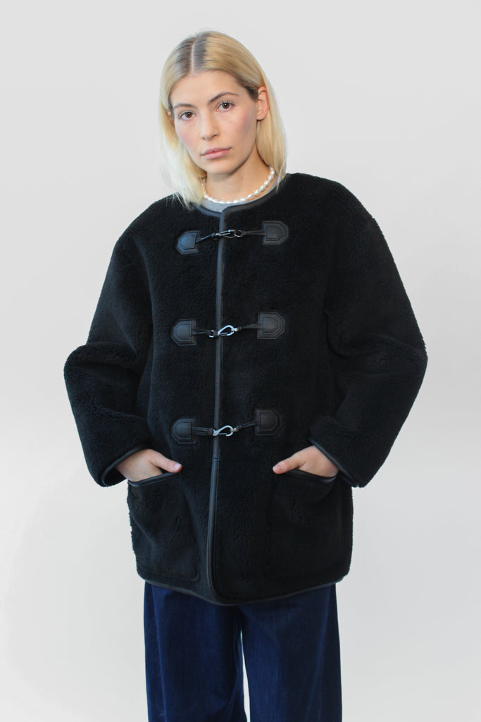 Dunst Collarless Buckled Shearling Jacket in Black at Parc Shop | Minneapolis, MN
