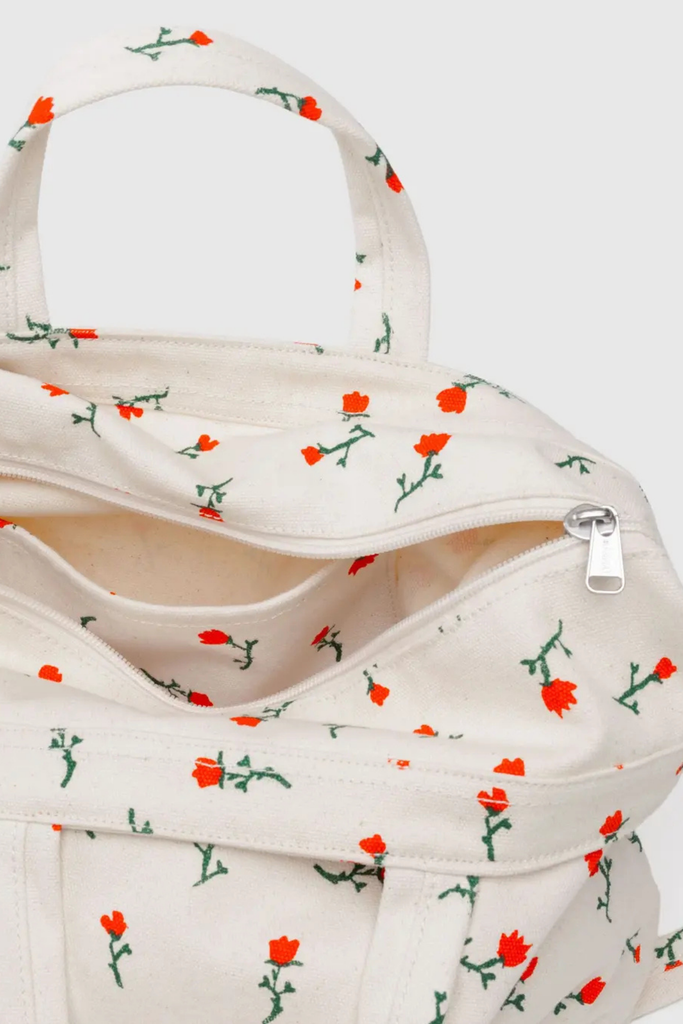 White bag with red floral pattern on a white background
