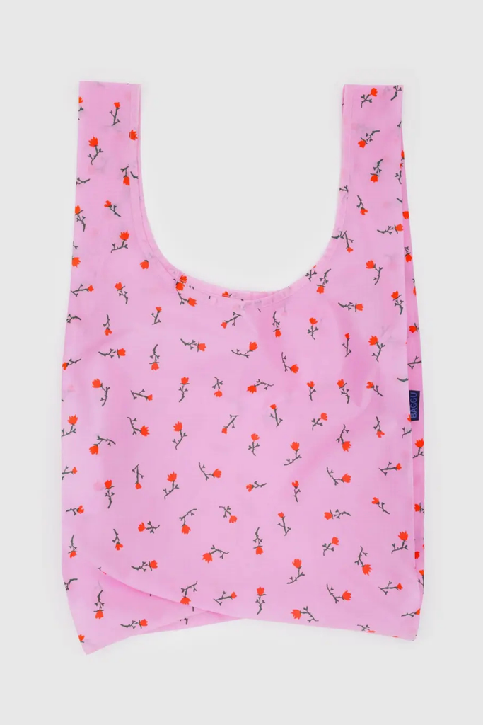 Pink reusable bag with floral pattern on a white background