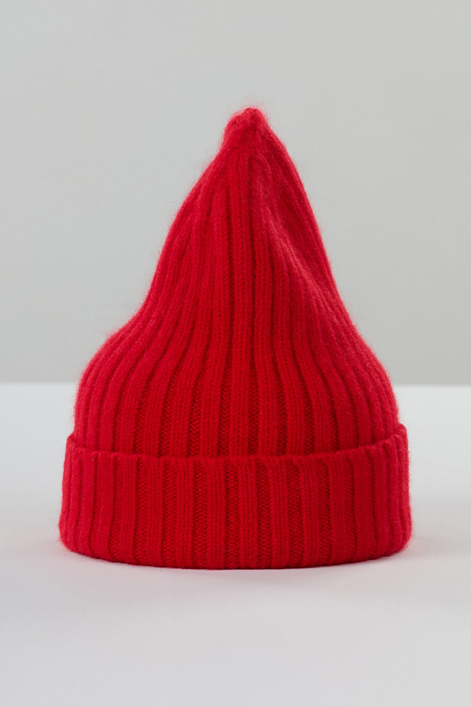 Red knitted beanie on a white background
