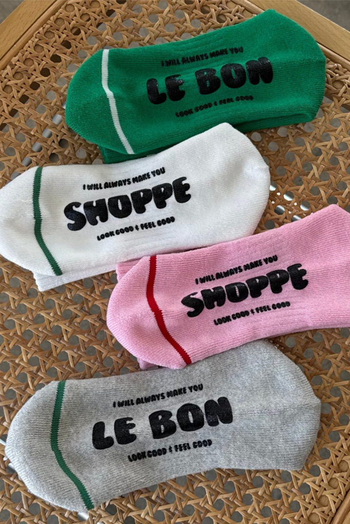 Four socks with text on a woven surface