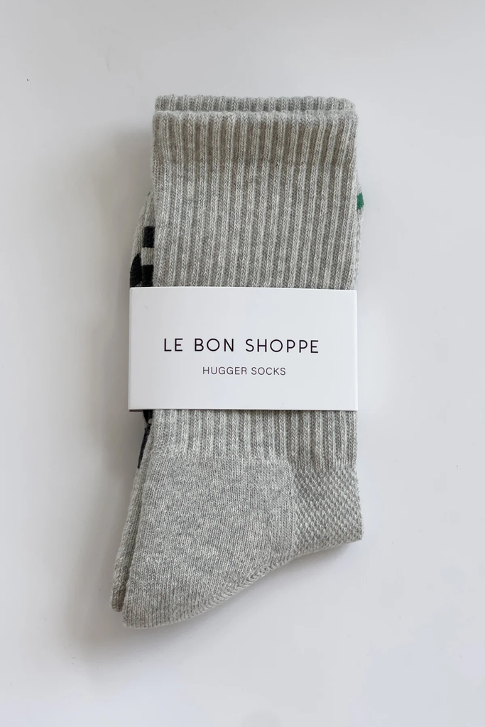 Packaged gray socks with 'Le Bon Shoppe' label on a white background