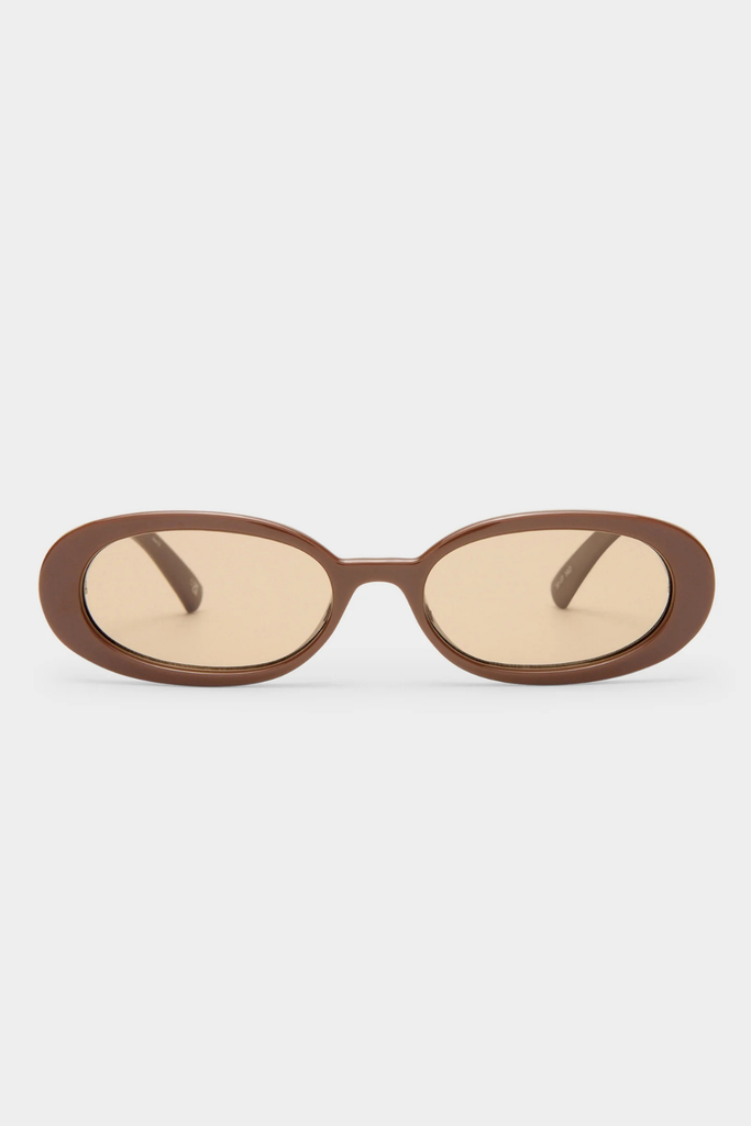 Brown oval sunglasses on a light beige background