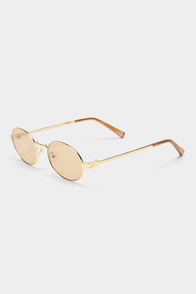 Gold-rimmed sunglasses on a white background
